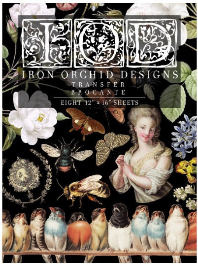 May include: Iron Orchid Designs Transfer Brocante. Eight 12' x 16' sheets.  The design features a dark background with white roses, butterflies, bees, birds, and a woman's portrait in a baroque style.  The color palette is predominantly dark with accents of white, gold, and muted jewel tones.  The sheets are for crafting and decorating projects.