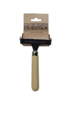 May include: A small, wooden-handled art roller with a metal frame and a brown rubber roller. The packaging shows the brand name Iron Orchid Designs and the words 'Art Roller'. The roller is designed for applying paint or other mediums to surfaces.